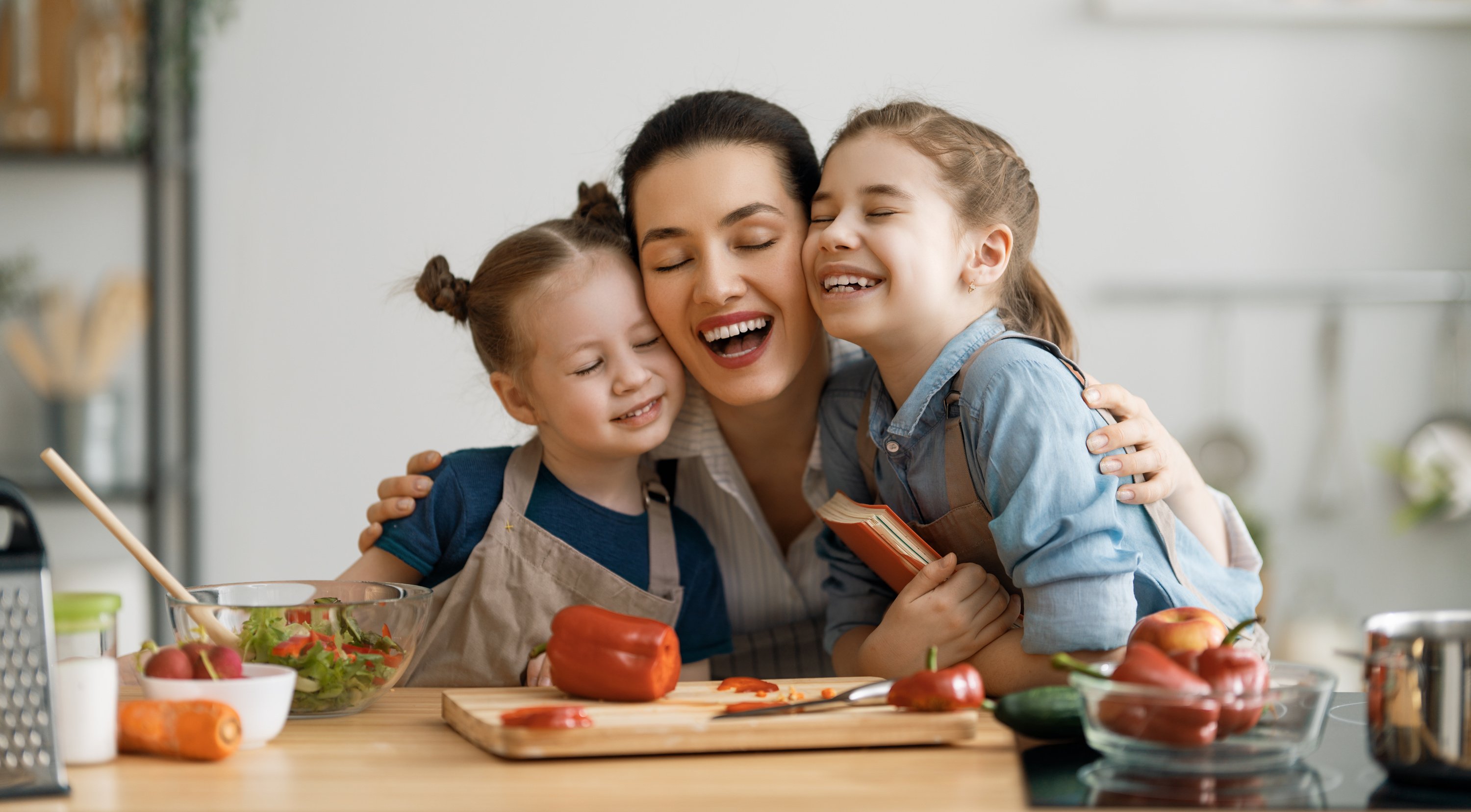 Mom with Daughters Cooking in the Kitchen